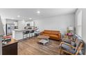 Open-concept living room featuring hardwood floors, modern furniture, and neutral paint at 4496 Springs Rd, Conover, NC 28613