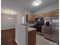 Open kitchen with stainless steel appliances, and laminate countertops, seamlessly flowing into dining area at 6724 Mallard Park Dr, Charlotte, NC 28262