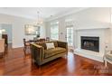 Cozy living room featuring a fireplace, dining area and comfortable seating at 800 Water Wheel Ct, Charlotte, NC 28209