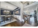 Open-concept floor plan featuring a dining room with dark blue walls and wood floors at 9762 Verdun Ct, Indian Land, SC 29707