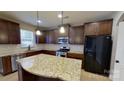 Modern kitchen boasts stainless steel appliances, granite countertops, and ample cabinet space for storage at 1007 Equipoise Dr, Indian Trail, NC 28079