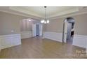 Bright living room featuring hardwood flooring, elegant trim, and an open layout, ideal for entertaining at 1007 Equipoise Dr, Indian Trail, NC 28079