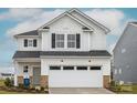 Charming two-story home with white siding, black shutters and a two-car garage, offering curb appeal and modern amenities at 13014 Garren View Ln # 306, Charlotte, NC 28278