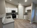 Bright kitchen featuring white cabinets, stainless steel appliances, and granite countertops at 1309 Meadow Ave, Kannapolis, NC 28083