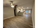 Open-concept living space with wood-look flooring and natural light at 1309 Meadow Ave, Kannapolis, NC 28083