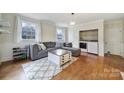 Cozy living room with wood floors, a comfortable gray sofa, and a convenient laundry area at 1501 Laurel Ln, Gastonia, NC 28054