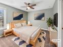 Cozy bedroom featuring stylish decor, a ceiling fan, plush carpet, and ample natural light at 15827 Arabian Mews Ln, Charlotte, NC 28278