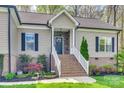 Close-up of the entryway with brick steps, white railing, and attractive front door at 1823 Rain Forest Dr, York, SC 29745