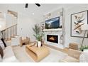 Modern living room featuring a fireplace with marble surround and hardwood floors at 2969 Beech Nut Rd, Charlotte, NC 28208