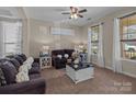 Inviting living room featuring plush sofas, decorative pillows, and natural light at 3181 Helmsley Ct, Concord, NC 28027