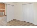 Cozy bedroom featuring laminate flooring and a closet with double doors for storage at 3701 Teaberry Ct, Charlotte, NC 28227