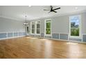 Bright and airy living room with hardwood floors, wainscoting, and large windows offering scenic views at 409 Henry Chapel Rd, Belmont, NC 28012