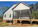 The backyard boasts a cozy screened porch with ceiling fan, offering a relaxing retreat at 409 Henry Chapel Rd, Belmont, NC 28012