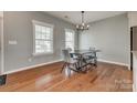 Well-lit dining area showcases hardwood floors, modern lighting, and a stylish table perfect for Gathering meals at 4219 Huntley Glen Dr, Pineville, NC 28134