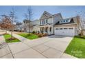 A beautiful house featuring manicured lawns and sidewalks leading up to the cozy covered front porch at 4219 Huntley Glen Dr, Pineville, NC 28134