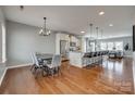 Spacious open-concept kitchen features stainless steel appliances, granite counters, and a large island with bar seating at 4219 Huntley Glen Dr, Pineville, NC 28134