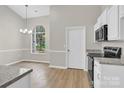 Bright kitchen and dining area featuring a large window and stainless steel appliances at 5923 Carriage Oaks Dr, Charlotte, NC 28262