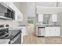 Bright kitchen with stainless steel appliances, white cabinetry and modern countertops at 5923 Carriage Oaks Dr, Charlotte, NC 28262