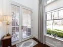 Bright foyer with views of the outdoors through large window and glass door at 6301 Park South Dr, Charlotte, NC 28210