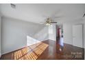 Bright living room featuring hardwood floors and large windows for ample natural light at 6310 Windsor Gate Ln # 15, Charlotte, NC 28215