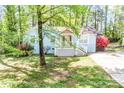 Charming blue brick home with a white picket fence and lush landscaping at 6628 Cool Water Ct, Charlotte, NC 28215