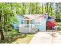 Inviting blue brick home featuring a well-manicured lawn and a cozy front porch at 6628 Cool Water Ct, Charlotte, NC 28215
