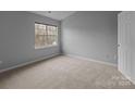 Neutral bedroom with carpet, a large window, and ample natural light at 7707 Petrea Ln, Charlotte, NC 28227