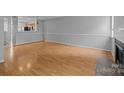 Spacious living room with wood floors, wainscoting and fireplace at 7707 Petrea Ln, Charlotte, NC 28227