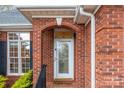 A welcoming front entrance featuring a beautifully decorated glass door and classic brick archway at 801 Toncin Ave, Bessemer City, NC 28016