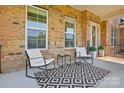 Inviting front porch with comfortable seating and stylish black and white outdoor rug at 8601 Balcony Bridge Rd, Huntersville, NC 28078