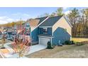 This two-story home boasts an attached garage, lush lawn, and a charming, traditional design at 967 Stebbins Dr, Fort Mill, SC 29715