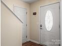 Bright entryway with a decorative front door and a staircase, offering a welcoming transition space at 1017 Village Green Ln, Rock Hill, SC 29730
