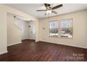 Inviting living room with gleaming hardwood floors, ceiling fan, and large windows at 1017 Village Green Ln, Rock Hill, SC 29730
