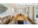 Dining room boasts a wooden table, seating for eight, large windows, and coffered ceilings at 1029 Merganser Way, Indian Trail, NC 28079