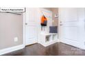 Functional mudroom with built-in bench, storage cubbies, and convenient coat hooks near the garage entrance at 1049 Merganser Way, Indian Trail, NC 28079