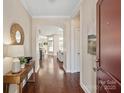 Open foyer featuring hardwood floors, arched doorways, and modern decor at 1128 Avalon Pl, Matthews, NC 28104