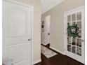 Bright hallway with hardwood floors, neutral walls, and decorative accents at 1519 Arcadia Bluff Dr, York, SC 29745