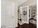 Open hallway with hardwood floors, decorative accents, and view into bedroom at 1519 Arcadia Bluff Dr, York, SC 29745