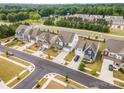 An aerial view of several charming two-story homes in a well-maintained neighborhood with mature trees at 16200 Winfield Hall Dr, Charlotte, NC 28273