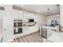 Bright kitchen featuring white cabinets, stainless steel appliances, and modern countertops at 16200 Winfield Hall Dr, Charlotte, NC 28273