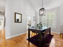 Bright dining room features vaulted ceilings, a modern light fixture, and an eye-catching area rug at 2310 Roswell Ave # H, Charlotte, NC 28207