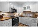 Charming kitchen featuring white cabinets, stainless steel appliances, and wooden countertops at 2503 Roswell Ave # 208, Charlotte, NC 28209