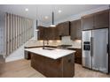 Modern kitchen with a large island, stainless steel appliances, and rich brown cabinetry at 3020 Georgia Ave, Charlotte, NC 28205