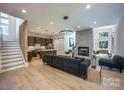 Bright, open living space with hardwood floors, modern fireplace, and seamless flow into the kitchen at 3020 Georgia Ave, Charlotte, NC 28205