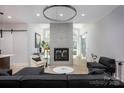 Elegant living room with a tiled fireplace, large windows, and contemporary furnishings at 3020 Georgia Ave, Charlotte, NC 28205