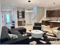Living area with modern furnishings, wet bar, and sleek staircase at 3020 Georgia Ave, Charlotte, NC 28205