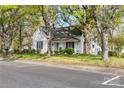 Quaint white home with well-maintained landscaping and a welcoming covered porch at 310 N Central Ave, Landis, NC 28088