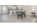 Modern kitchen with breakfast bar, stainless steel appliances, and adjacent dining area at 336 B Lincoln St, Concord, NC 28025