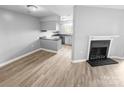 Living room area with a fireplace and view of the adjoining kitchen at 4814 Spring Lake Dr # B, Charlotte, NC 28212