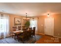 Charming dining room showcasing wood floors, and an elegant chandelier at 513 Buttercup Way, Fort Mill, SC 29715